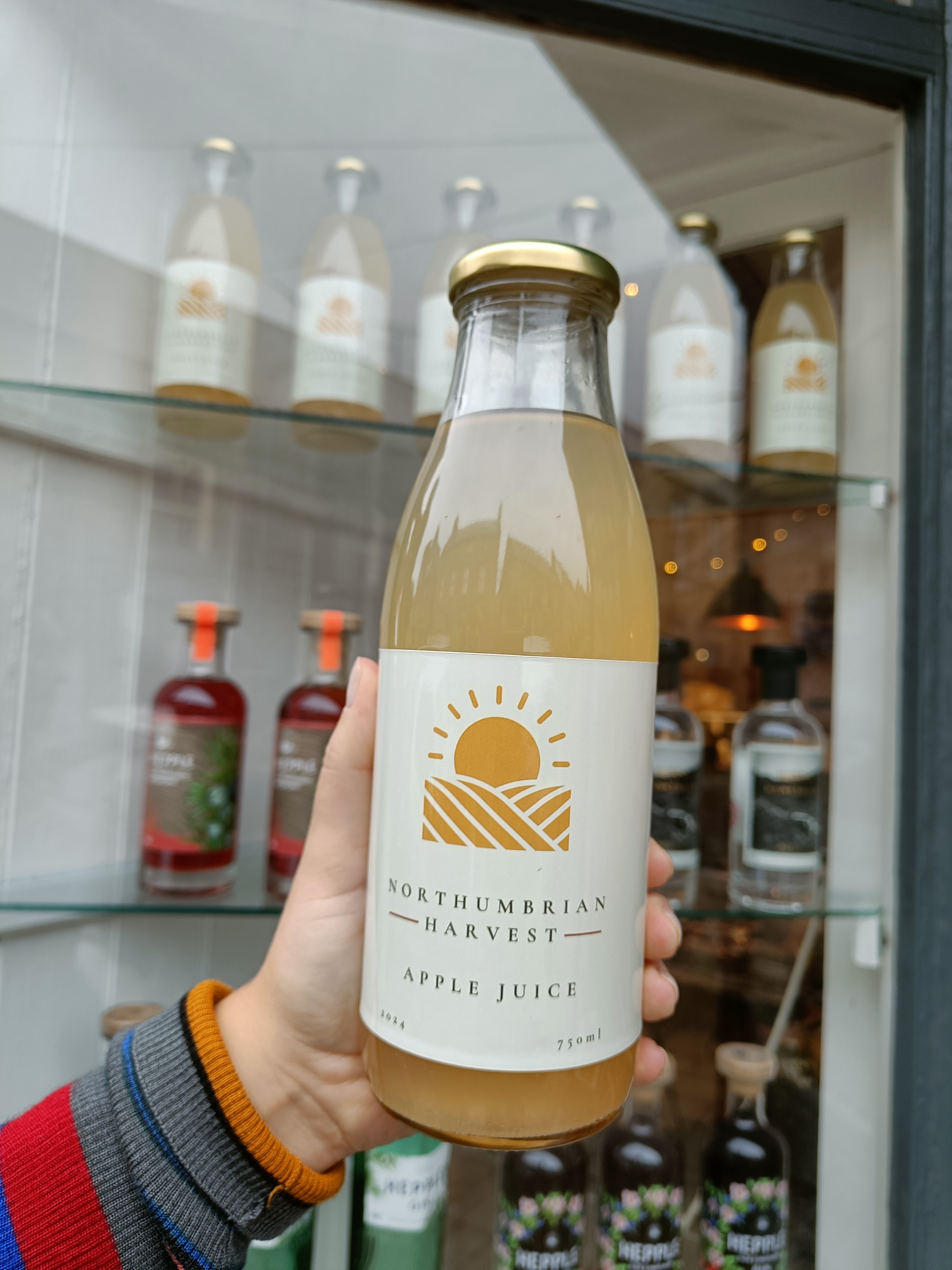 Northumbrian apple juice bottle close-up in front of shop